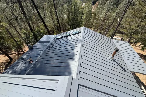 Old corrugated metal to charcoal standing seam, with new skylights