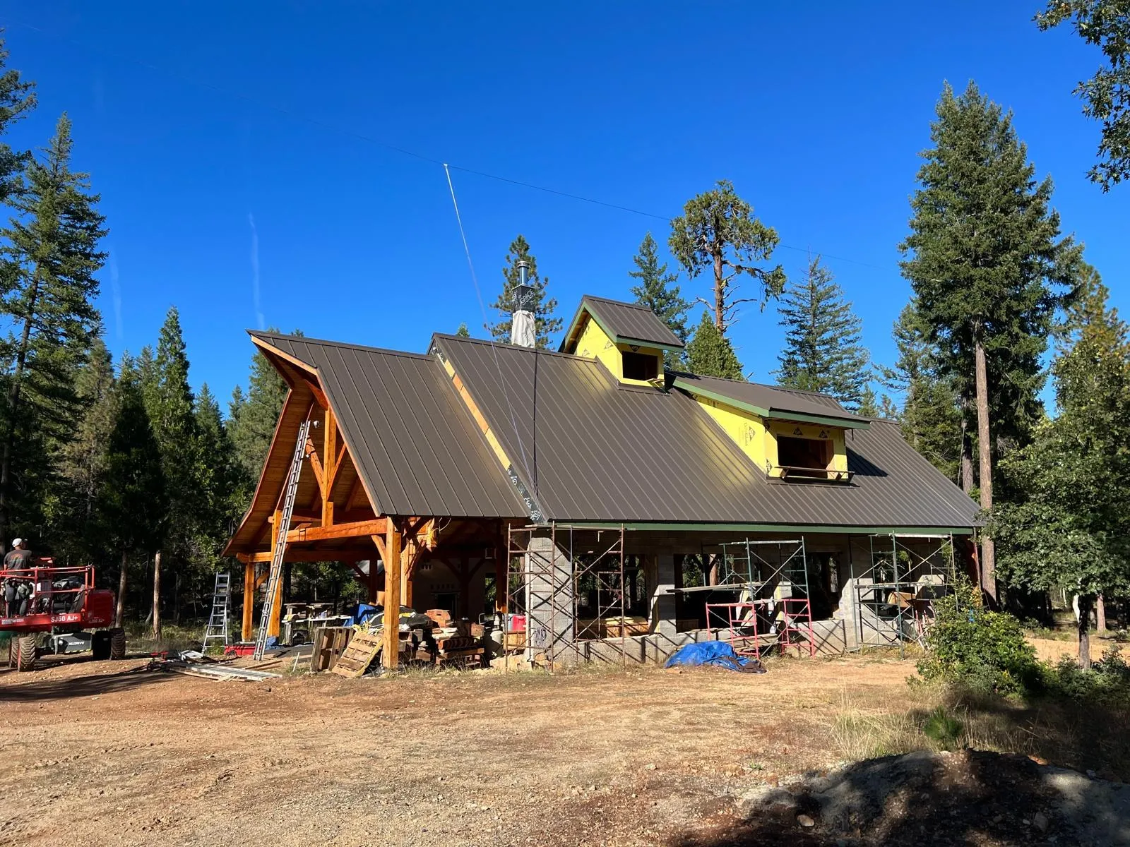 After: Timber-frame home with a bronze standing seam roof