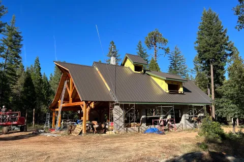 Timber-frame home with a bronze standing seam roof
