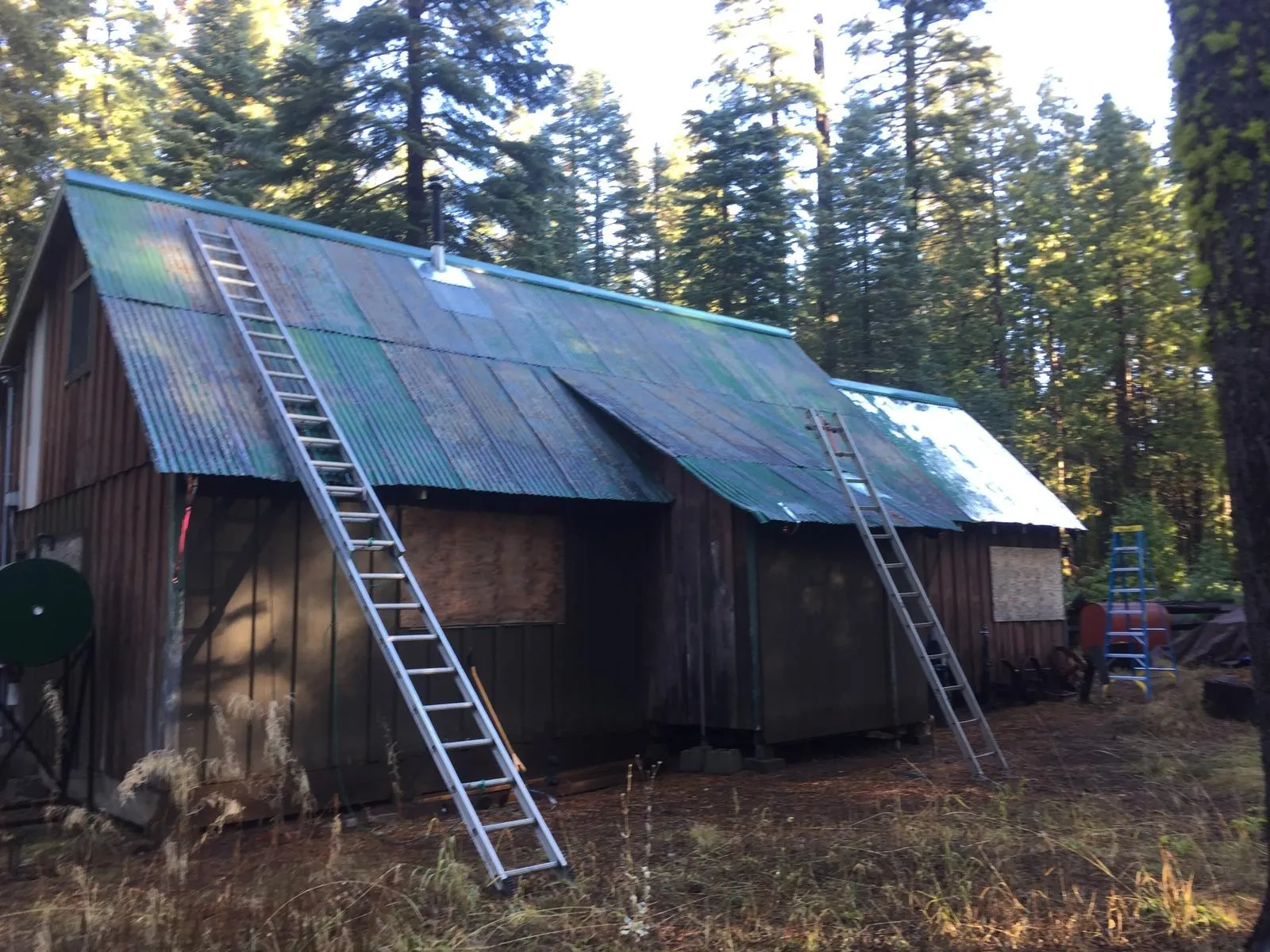 Before: Cabin in the pines: old roof to green standing seam