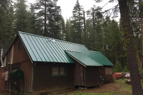 Cabin in the pines: old roof to green standing seam