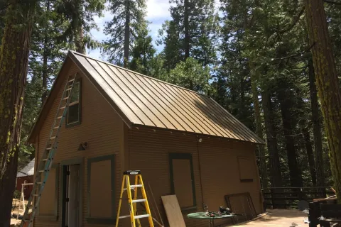 Mountain cabin re-roof in standing seam metal
