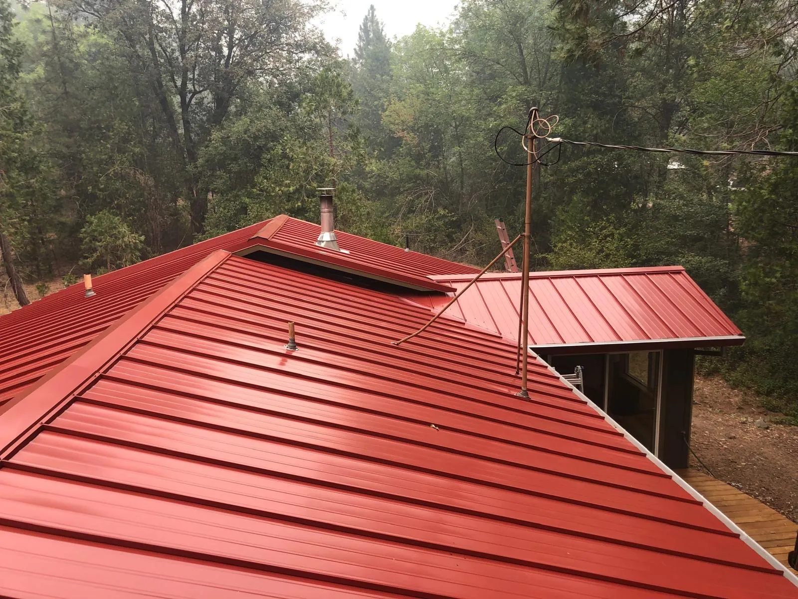 After: Red standing seam metal roof