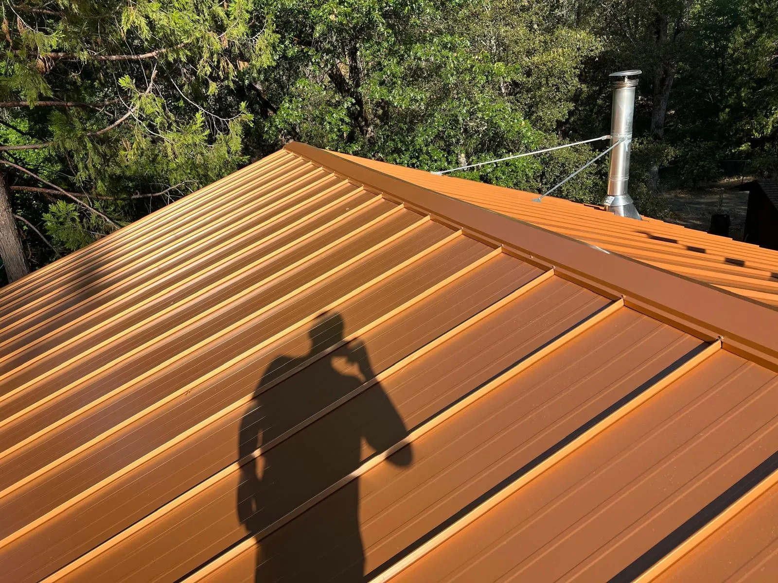 After: Copper-colored standing seam metal roof