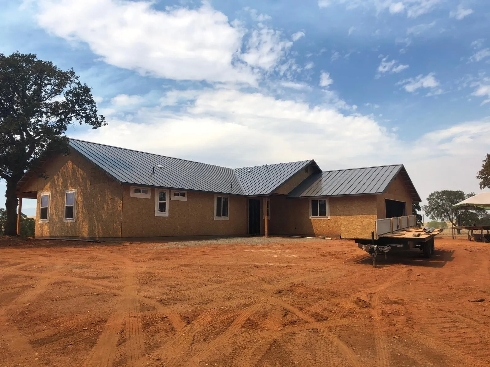 After: Dark standing seam roof on a ranch-style home
