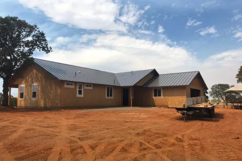 Dark standing seam roof on a ranch-style home