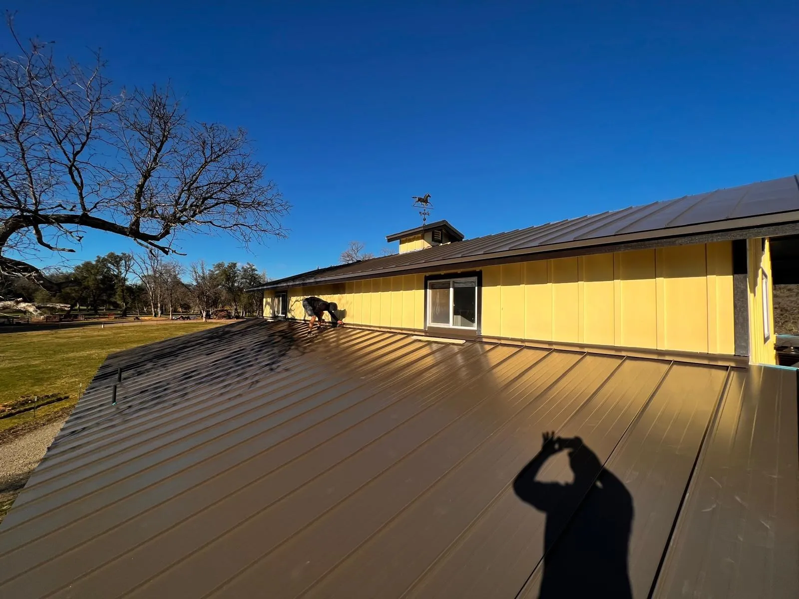 After: Yellow building with a dark standing seam roof