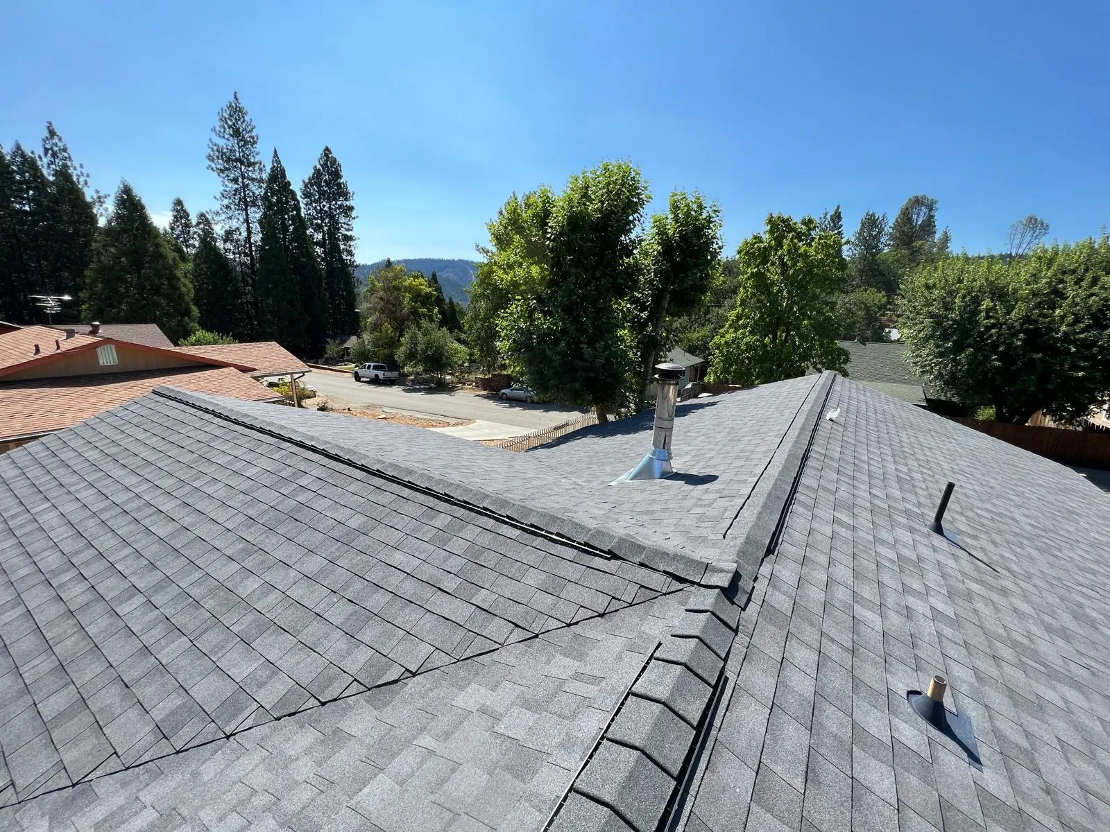 After: Composition shingle roof with ridge cap and vents