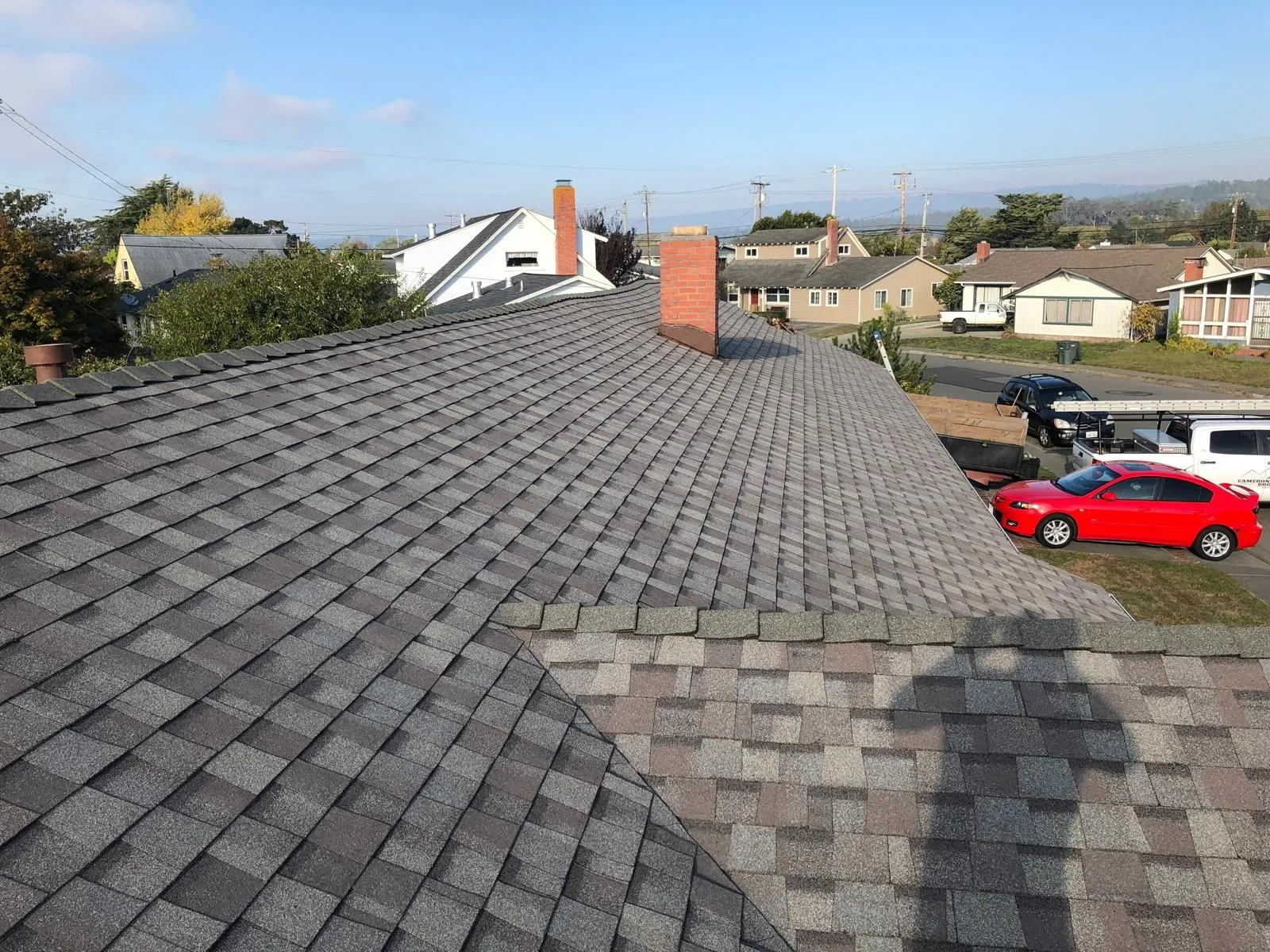 After: Neighborhood re-roof in composition shingles